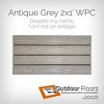 Roman Antique Grey 2x1-foot composite deck tile. Four-slat balcony flooring tile with embossed wood grain. Medium-bright grey with embossed wood grain pattern in each slat. Slight yellow/sepia tone to tile. Caption reads, “Despite my name, I am not an antique”. Composites are KING of balcony flooring!