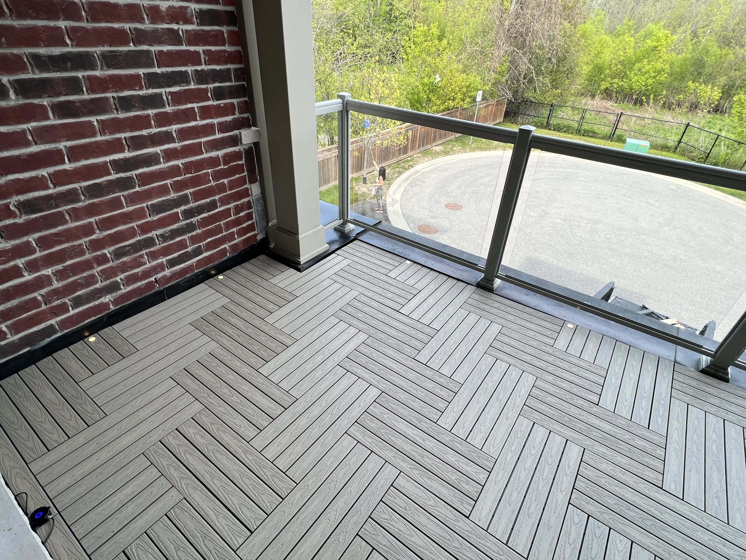 Modern townhouse balcony in Pickering featuring Roman Antique 1x2 WPC deck tiles and integrated balcony deck lights.