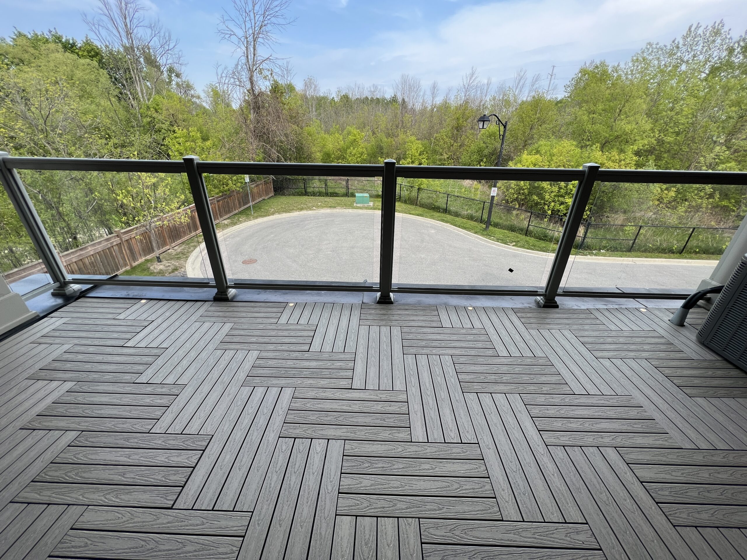 Modern townhouse balcony in Pickering featuring Roman Antique 1x2 WPC deck tiles and integrated balcony deck lights.