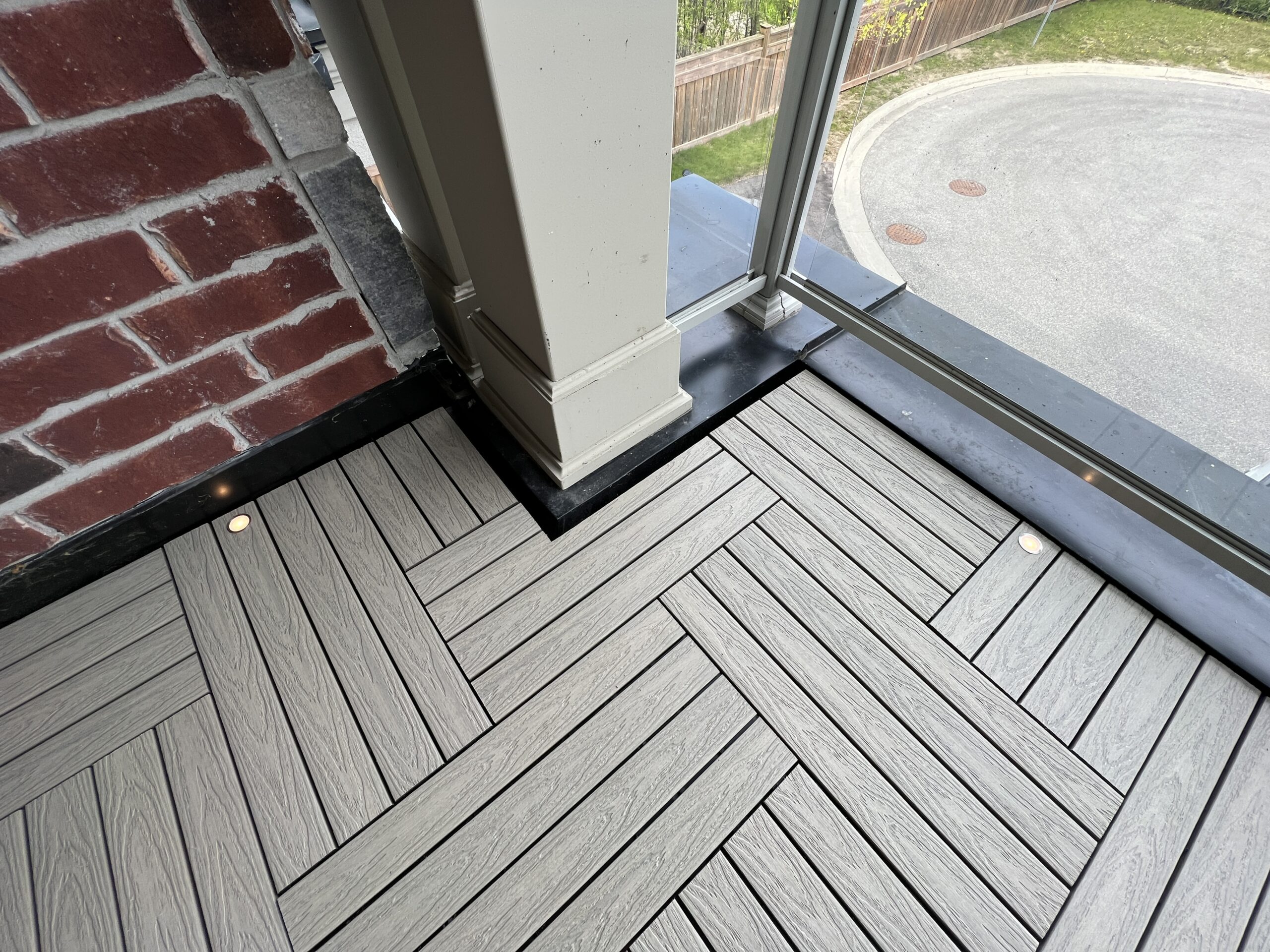 Modern townhouse balcony in Pickering featuring Roman Antique 1x2 WPC deck tiles and integrated balcony deck lights.