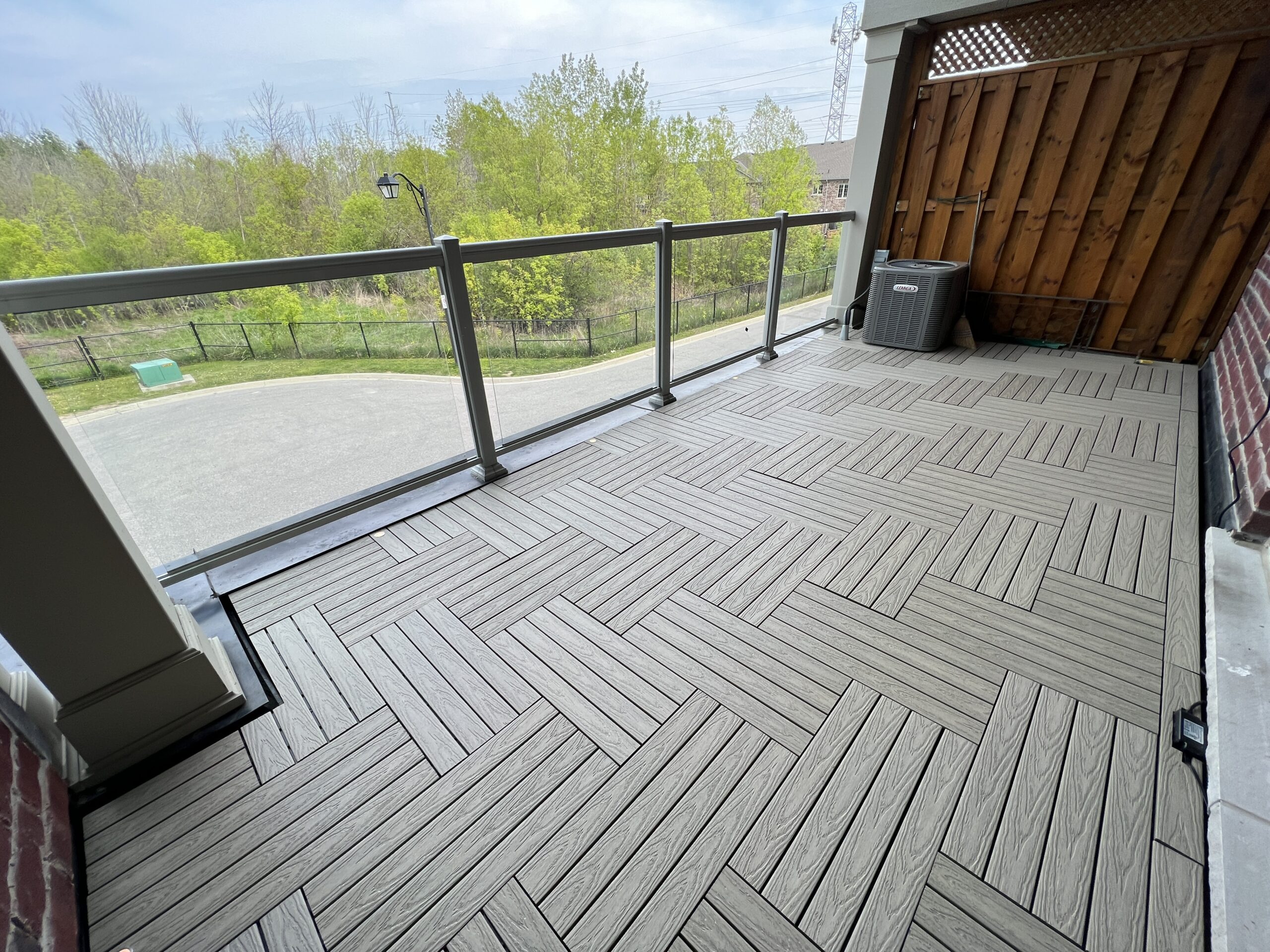 Modern townhouse balcony in Pickering featuring Roman Antique 1x2 WPC deck tiles and integrated balcony deck lights.