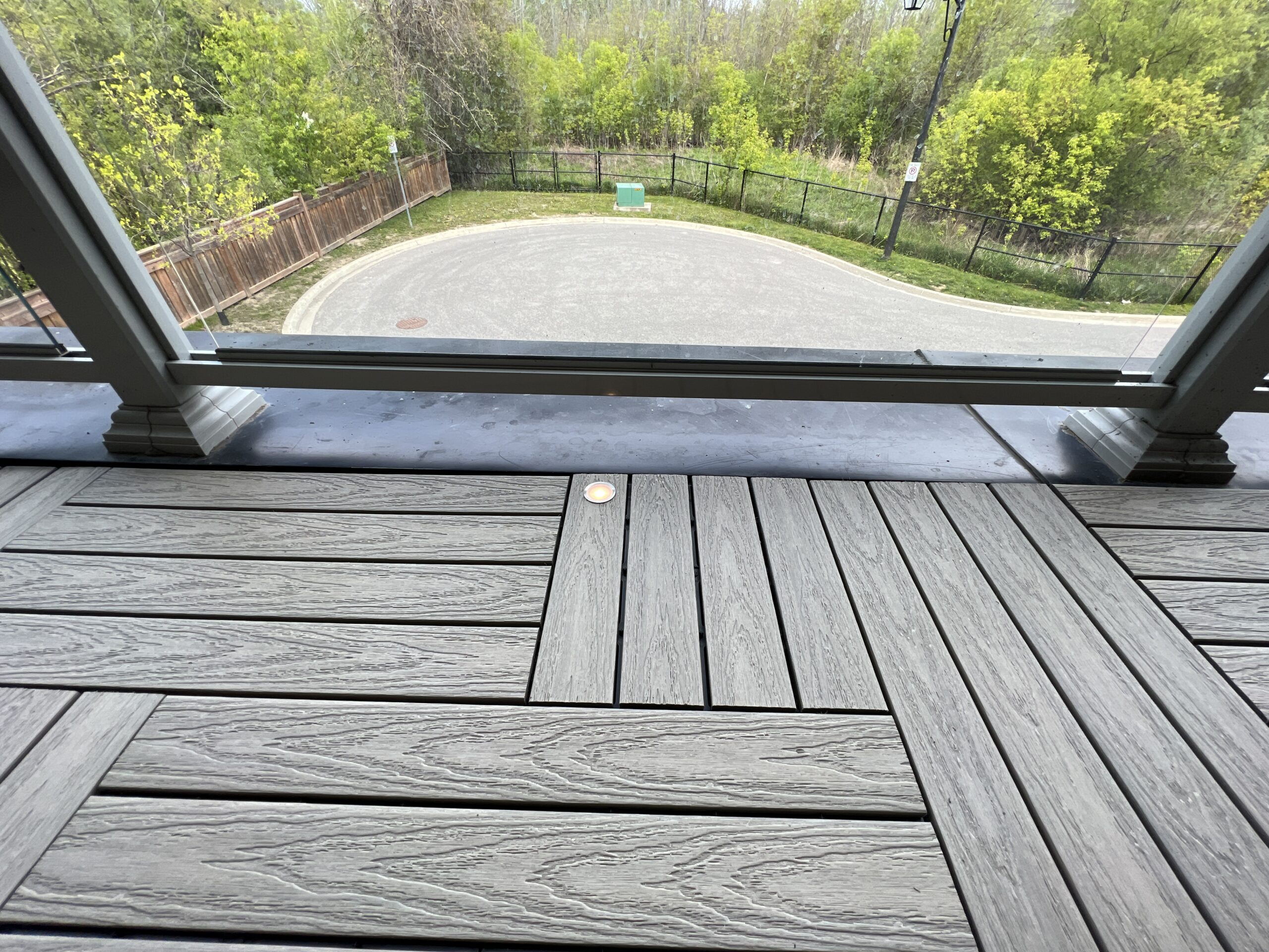 Modern townhouse balcony in Pickering featuring Roman Antique 1x2 WPC deck tiles and integrated balcony deck lights.