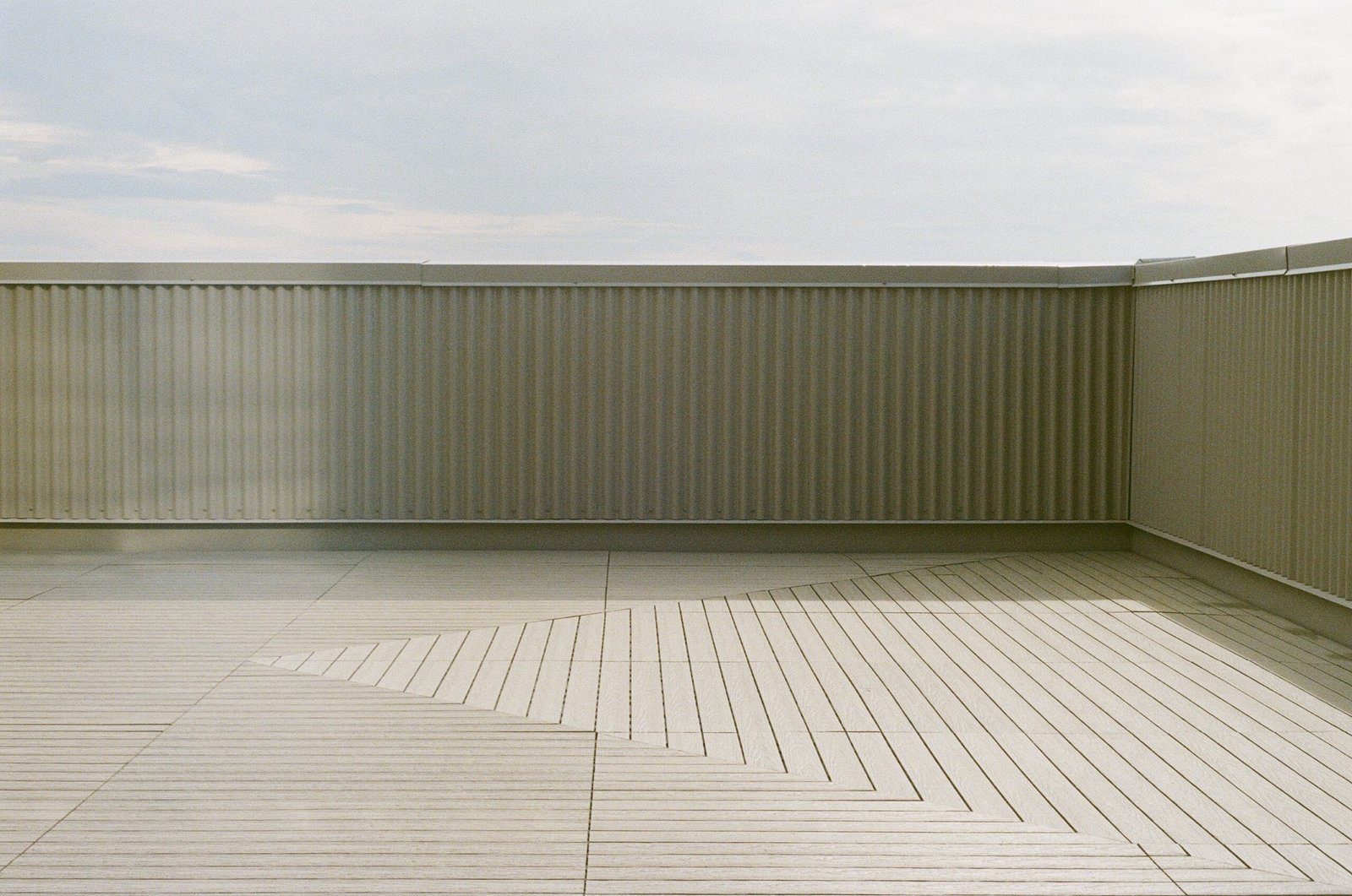 Finished balcony with a patterned composite deck tile floor