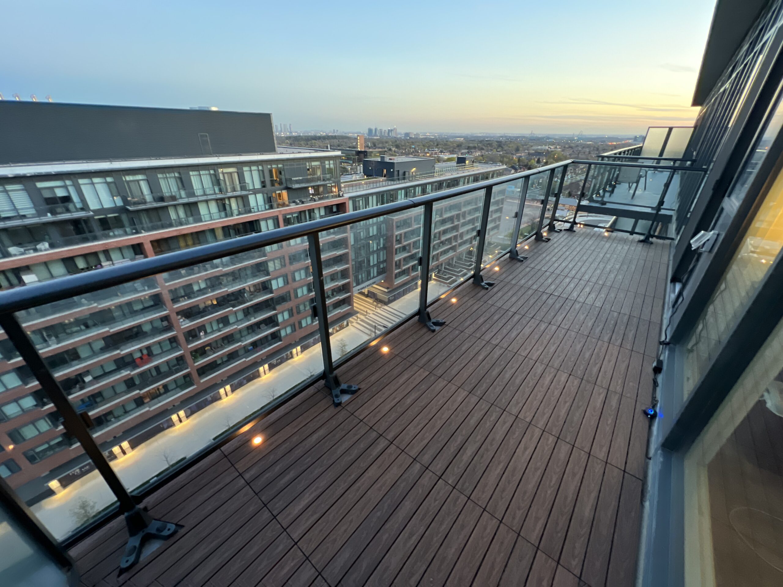 IPE 1x2 WPC deck tiles installed in a linear pattern on an open condo balcony in Vaughan, featuring built-in deck lights