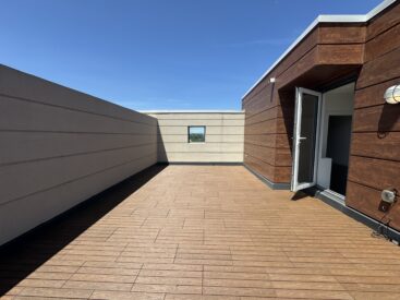 Teak 1x2 WPC deck tiles installed in a staggered pattern on a rooftop terrace of a townhouse in Ajax, complete with deck lights