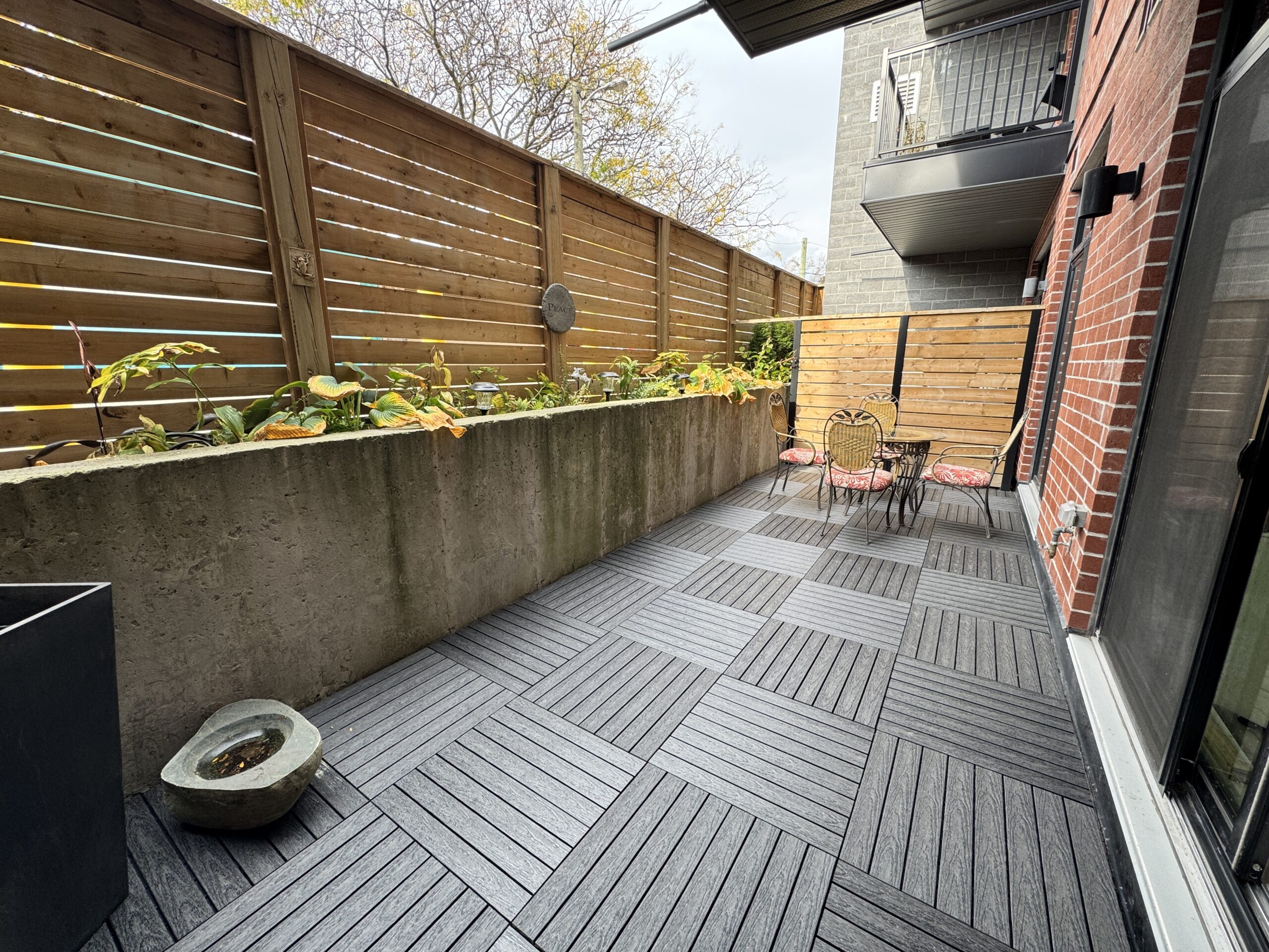 Charcoal 1x2 WPC deck tiles installed in a parquet pattern on a condo balcony in East York, Toronto