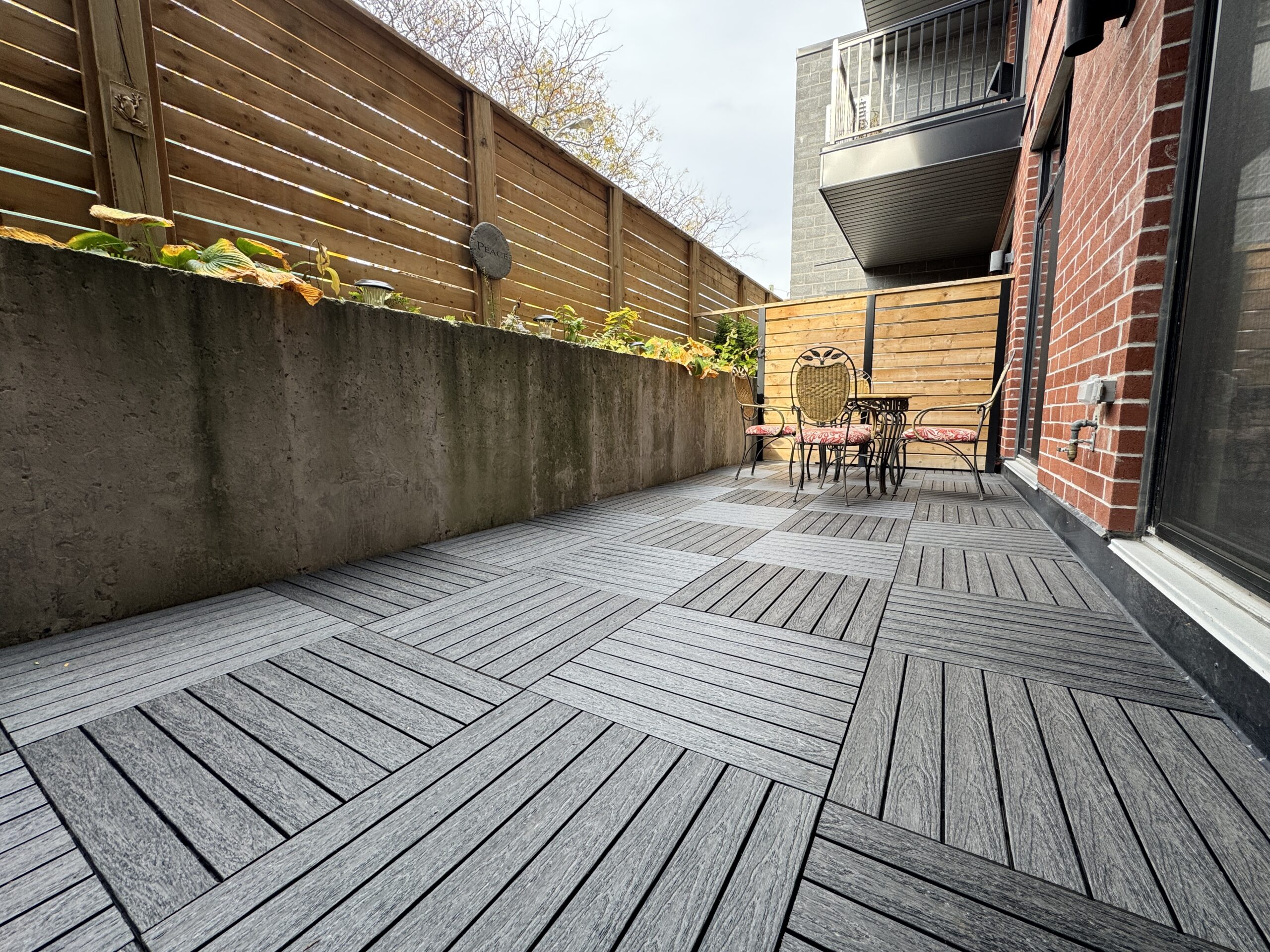 Charcoal 1x2 WPC deck tiles installed in a parquet pattern on a condo balcony in East York, Toronto.