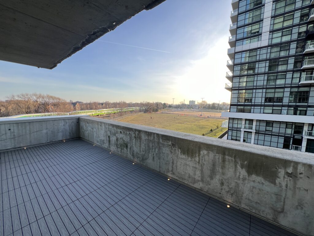 Modern condo balcony in Etobicoke featuring Light Grey 1x2 WPC deck tiles and integrated balcony deck lights.